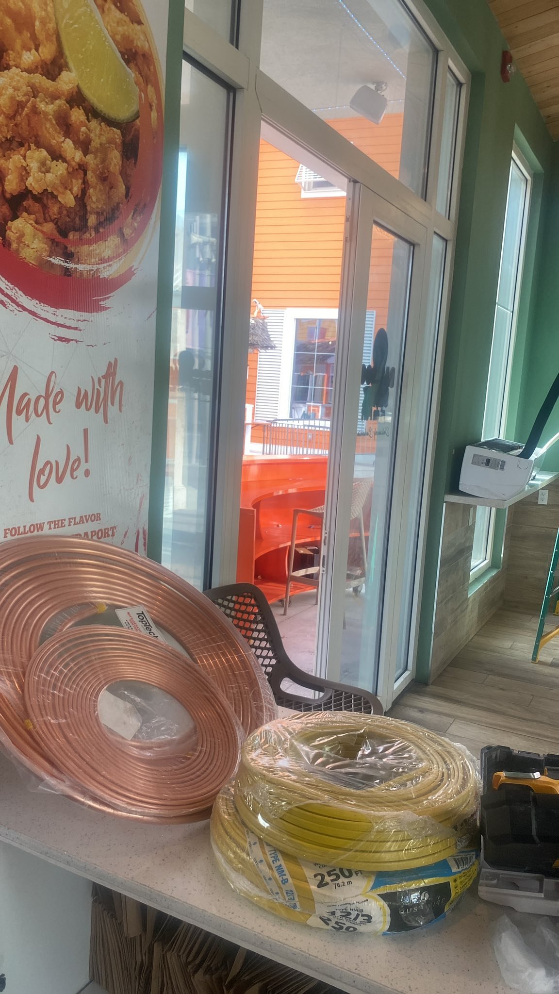 AC installation with copper pipe and wiring supplies at a Nassau restaurant