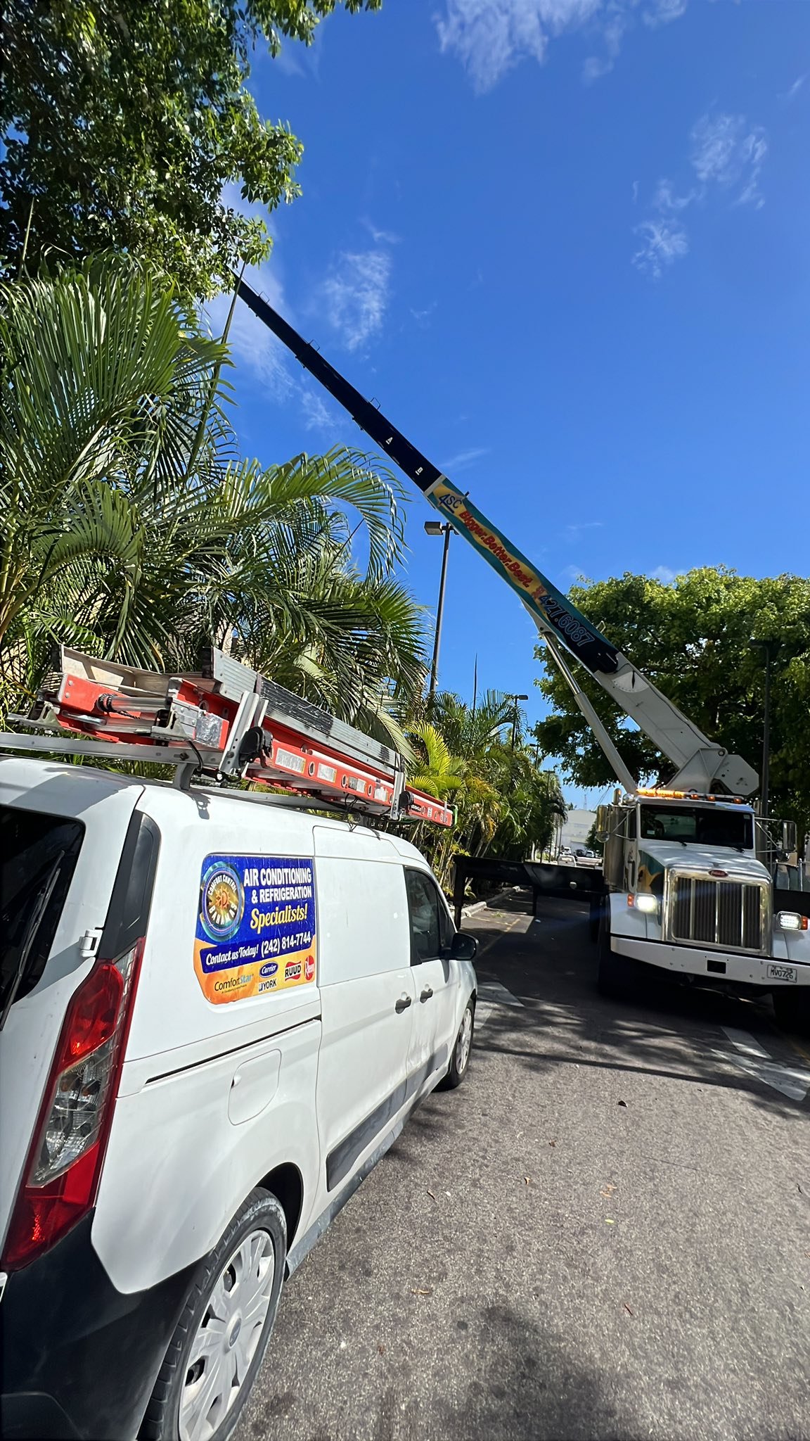Comfort Control Bahamas branded work van at a large job site
