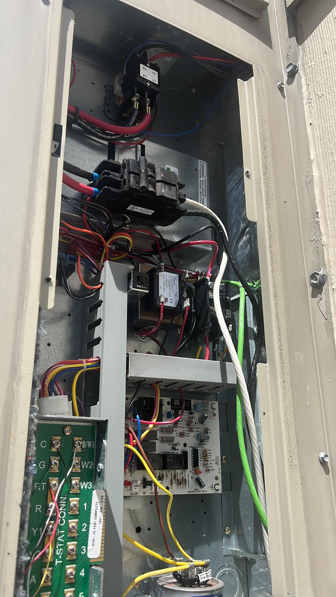 Inside view of commercial AC electrical panel and wiring